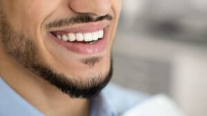 Closeup Of Happy Young Man Smiling With Perfect Teeth